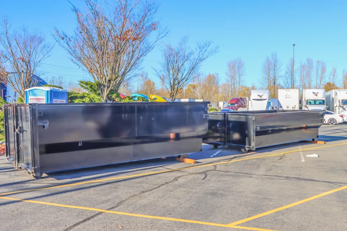 Professional dumpster rental service with roll-off container on residential driveway in Travelers Rest